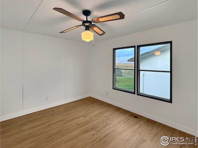 306 E Arapahoe St, Fleming, CO 80728 - empty room with wood finished floors, baseboards, and ceiling fan