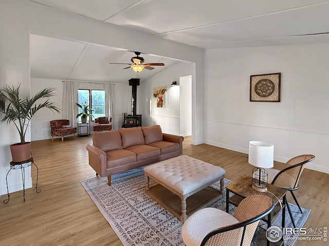 306 E Arapahoe St, Fleming, CO 80728 - living area with a wood stove, light wood-style floors, baseboards, and a ceiling fan