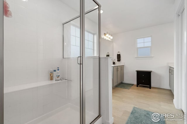 1958 Autumn Moon Dr, Windsor, CO 80550 - bathroom with vanity, a stall shower, and wood finished floors