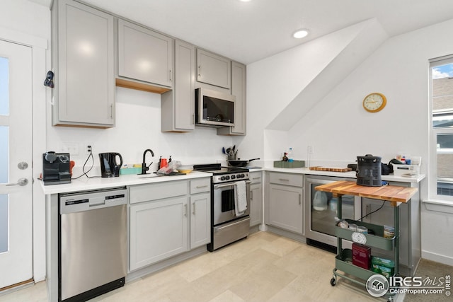 1958 Autumn Moon Dr, Windsor, CO 80550 - kitchen featuring appliances with stainless steel finishes, gray cabinets, light countertops, wine cooler, and recessed lighting