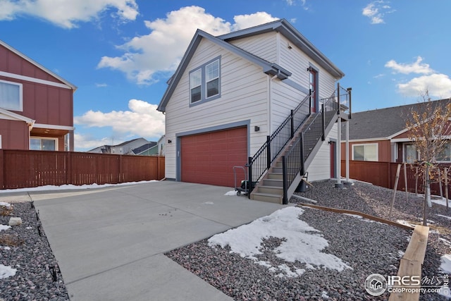 1958 Autumn Moon Dr, Windsor, CO 80550 - view of side of home with an attached garage, concrete driveway, and stairway