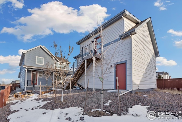 1958 Autumn Moon Dr, Windsor, CO 80550 - snow covered house featuring a porch and a garage