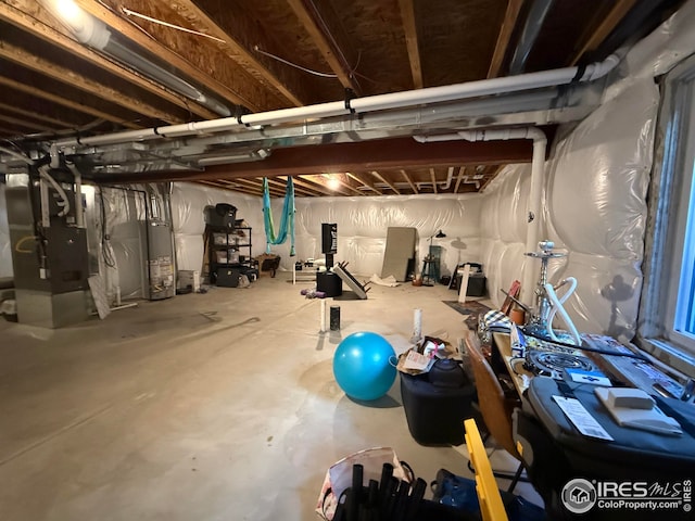 706 S Prairie Dr, Milliken, CO 80543 - unfinished below grade area featuring gas water heater and heating unit