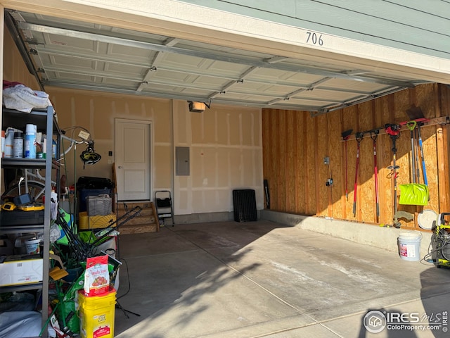706 S Prairie Dr, Milliken, CO 80543 - garage featuring electric panel and a garage door opener