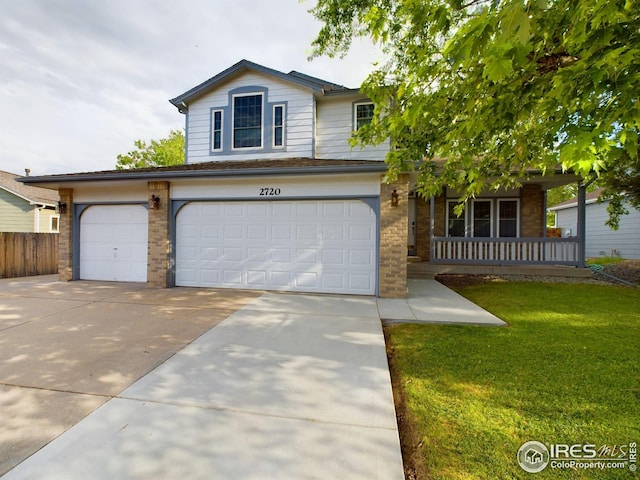 2720 E 121st Pl, Thornton, CO 80241 - view of front of property with brick siding, covered porch, concrete driveway, and an attached garage