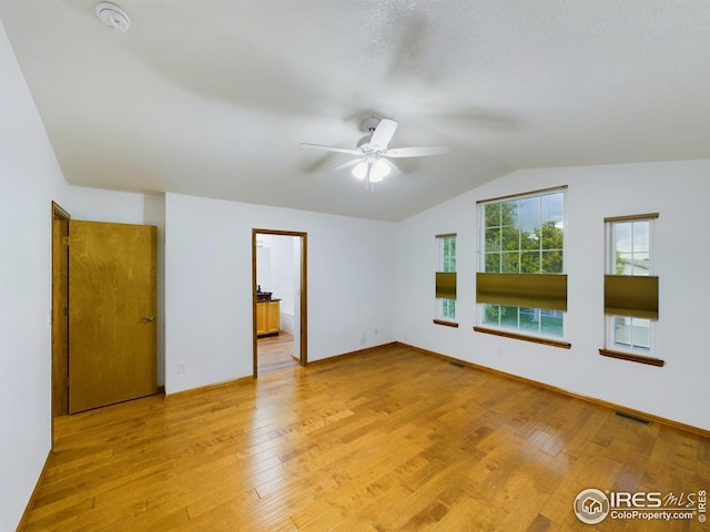 2720 E 121st Pl, Thornton, CO 80241 - unfurnished bedroom with vaulted ceiling and light wood-style flooring