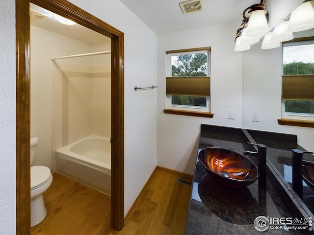 2720 E 121st Pl, Thornton, CO 80241 - bathroom featuring wood finished floors, bathing tub / shower combination, and vanity