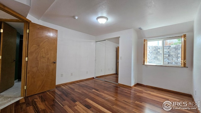 2720 E 121st Pl, Thornton, CO 80241 - unfurnished bedroom featuring wood finished floors and a closet