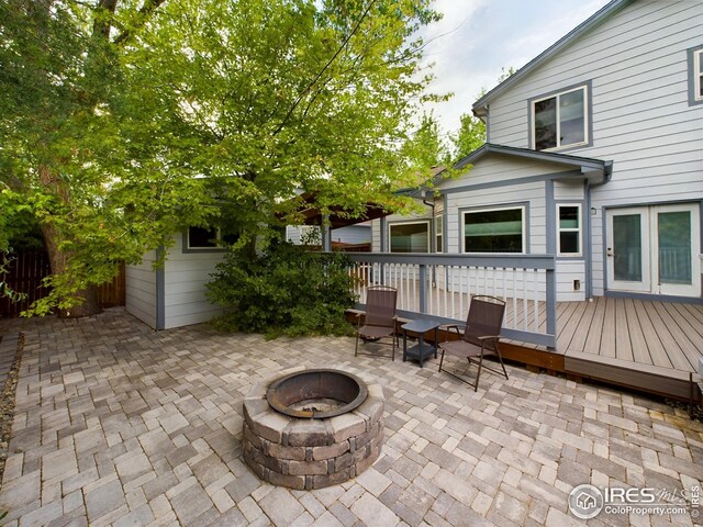 2720 E 121st Pl, Thornton, CO 80241 - view of patio / terrace with a fire pit and a wooden deck