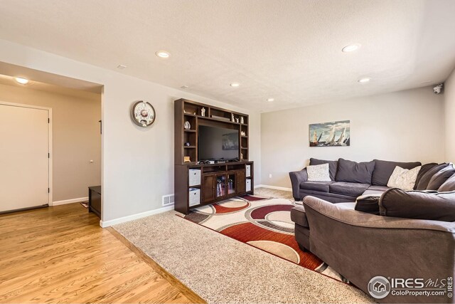 2447 E 100th Way, Thornton, CO 80229 - living room with recessed lighting, baseboards, and wood finished floors