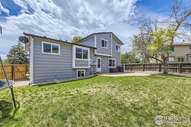 2447 E 100th Way, Thornton, CO 80229 - back of property with a patio and a trampoline
