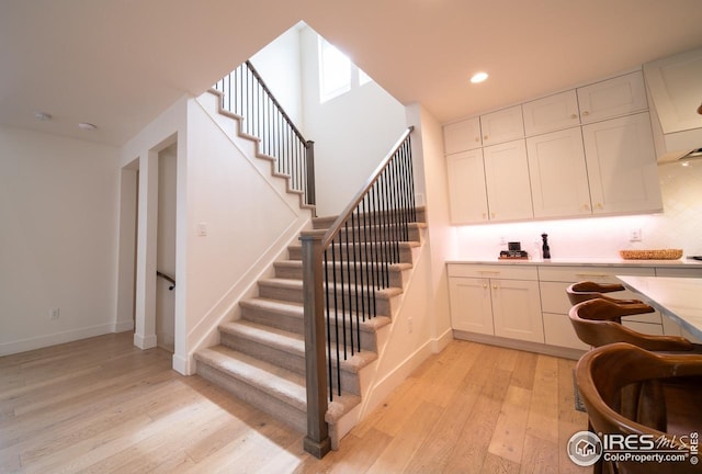 9415 E 58th Dr, Denver, CO 80238 - staircase with wood finished floors, baseboards, and recessed lighting