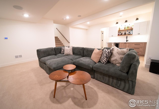 9415 E 58th Dr, Denver, CO 80238 - living area featuring wet bar, light colored carpet, stairs, recessed lighting, and baseboards