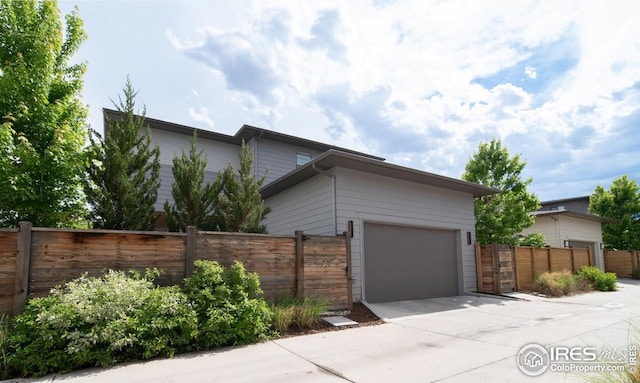 9415 E 58th Dr, Denver, CO 80238 - view of side of home featuring concrete driveway and an attached garage