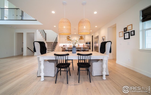 9415 E 58th Dr, Denver, CO 80238 - dining room with stairway, light wood-style floors, recessed lighting, and baseboards