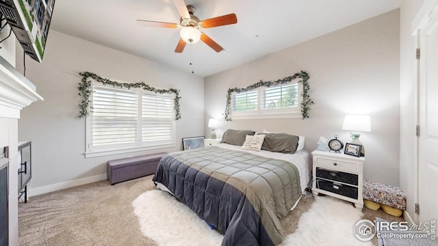 4642 Hahns Peak Dr Unit 101, Loveland, CO 80538 - bedroom featuring carpet floors, a fireplace, baseboards, and a ceiling fan