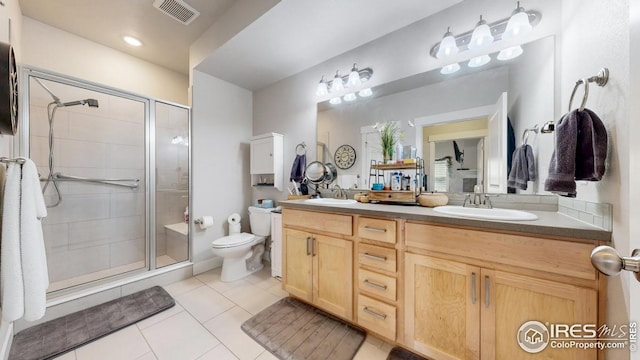 4642 Hahns Peak Dr Unit 101, Loveland, CO 80538 - bathroom featuring double vanity, a shower stall, toilet, and tile patterned flooring