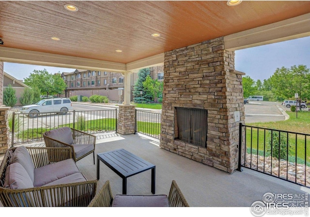 4642 Hahns Peak Dr Unit 101, Loveland, CO 80538 - porch with an outdoor living space with a fireplace