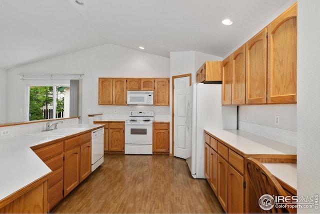 474 Radiant Dr, Loveland, CO 80538 - kitchen with white appliances, a sink, lofted ceiling, light countertops, and wood finished floors
