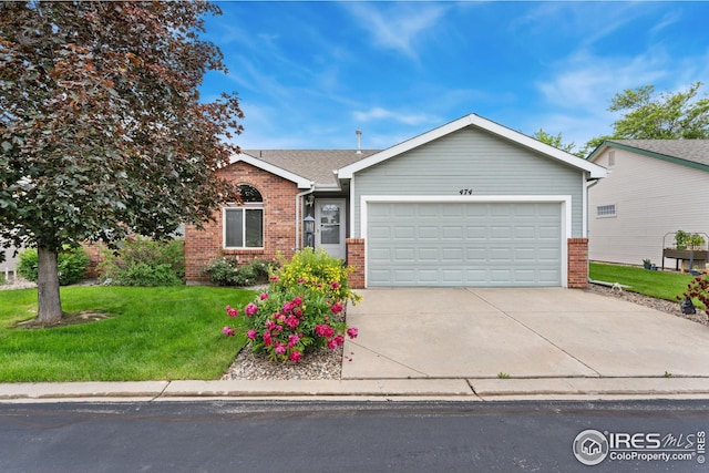 474 Radiant Dr, Loveland, CO 80538 - view of front of house with brick siding, a garage, concrete driveway, and a front lawn