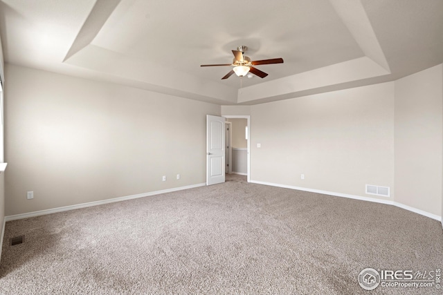 848 Shirttail Peak Dr, Windsor, CO 80550 - spare room featuring a raised ceiling, a ceiling fan, carpet flooring, and baseboards