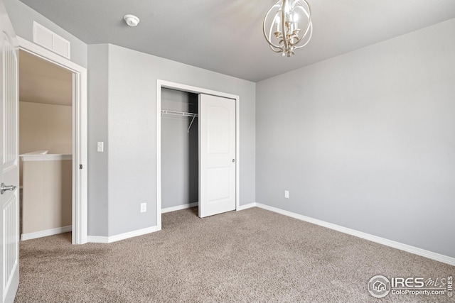848 Shirttail Peak Dr, Windsor, CO 80550 - unfurnished bedroom with carpet flooring, a chandelier, baseboards, and a closet