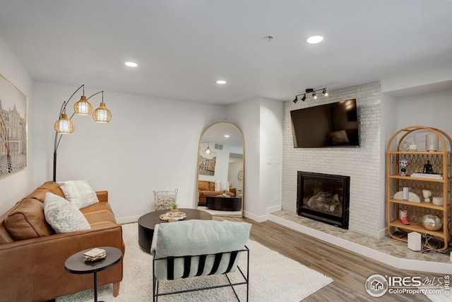 2802 Sundown Ln Unit 210, Boulder, CO 80303 - living room featuring wood finished floors, a fireplace, and recessed lighting