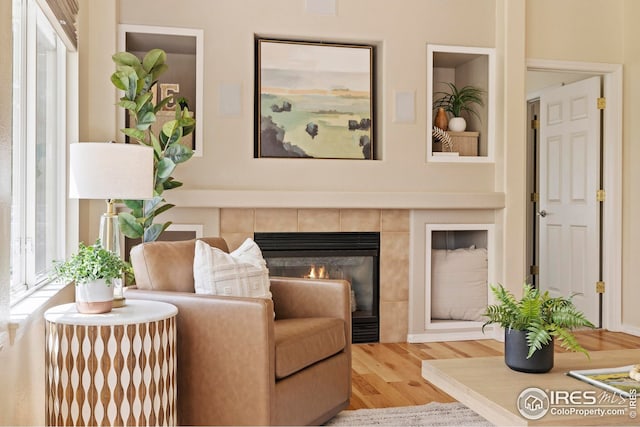1427 Reeves Dr, Fort Collins, CO 80526 - living room featuring wood finished floors and a tiled fireplace