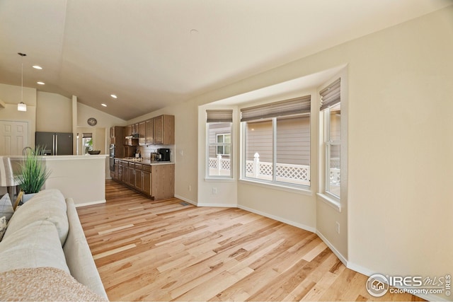 1427 Reeves Dr, Fort Collins, CO 80526 - living room with light wood-style flooring, vaulted ceiling, recessed lighting, and baseboards