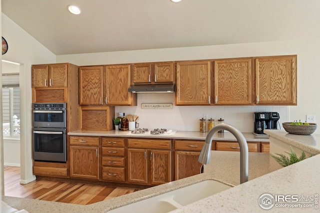 1427 Reeves Dr, Fort Collins, CO 80526 - kitchen with double oven, a sink, brown cabinetry, and recessed lighting