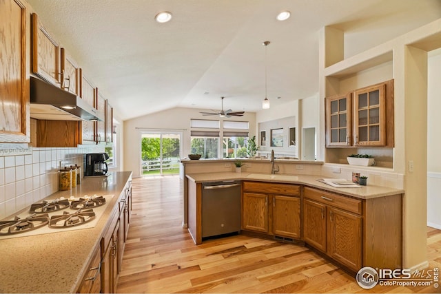 1427 Reeves Dr, Fort Collins, CO 80526 - kitchen with dishwasher, a sink, white gas cooktop, brown cabinets, and under cabinet range hood