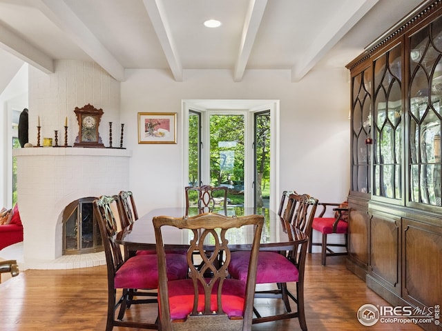 8000 N 41st St, Longmont, CO 80503 - dining space featuring beamed ceiling, dark wood-type flooring, a fireplace, and recessed lighting