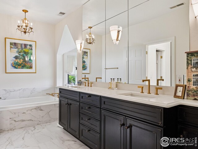 8000 N 41st St, Longmont, CO 80503 - bathroom featuring a chandelier, double vanity, marble finish flooring, and a garden tub