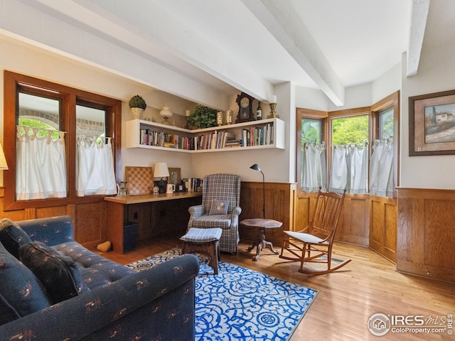 8000 N 41st St, Longmont, CO 80503 - sitting room featuring beam ceiling, wainscoting, wood finished floors, and wooden walls