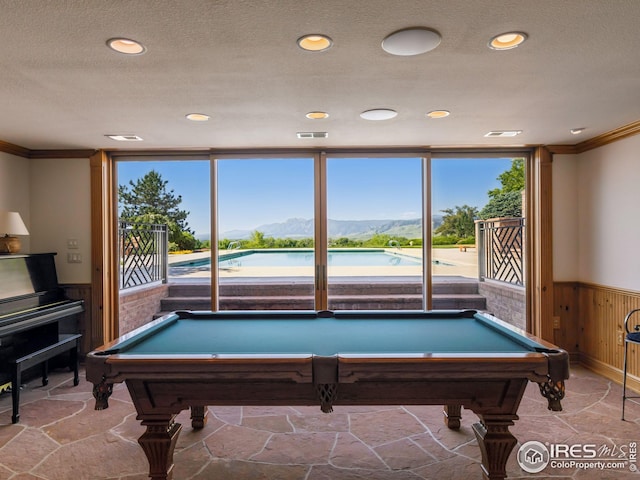 8000 N 41st St, Longmont, CO 80503 - playroom with wainscoting, ornamental molding, pool table, plenty of natural light, and stone finish floors