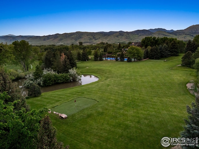 8000 N 41st St, Longmont, CO 80503 - view of property's community featuring a water and mountain view, a putting green, a lawn, and golf course view