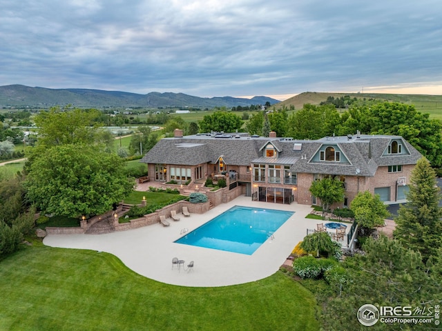 8000 N 41st St, Longmont, CO 80503 - back of property with a patio, a yard, and a mountain view