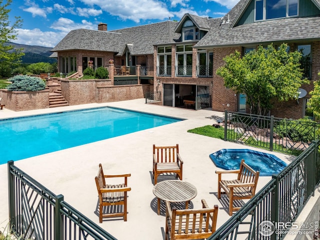8000 N 41st St, Longmont, CO 80503 - view of swimming pool featuring a patio area, a hot tub, and stairway