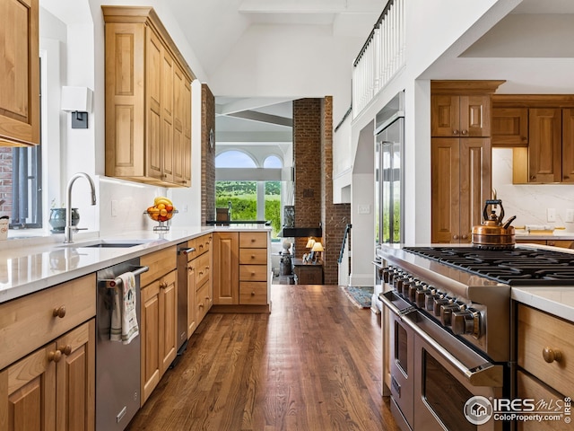 8000 N 41st St, Longmont, CO 80503 - kitchen with appliances with stainless steel finishes, dark wood finished floors, backsplash, light countertops, and lofted ceiling