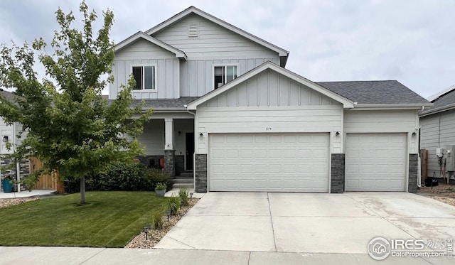 879 Depot Dr, Milliken, CO 80543 - view of front of house with board and batten siding, driveway, a garage, a front lawn, and roof with shingles