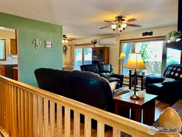 1722 Pheasant Rdg, Sterling, CO 80751 - living room with an AC wall unit, ceiling fan, a textured ceiling, and a baseboard heating unit