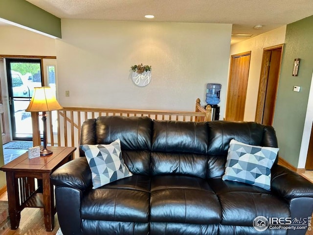 1722 Pheasant Rdg, Sterling, CO 80751 - living area featuring wood finished floors and a textured ceiling
