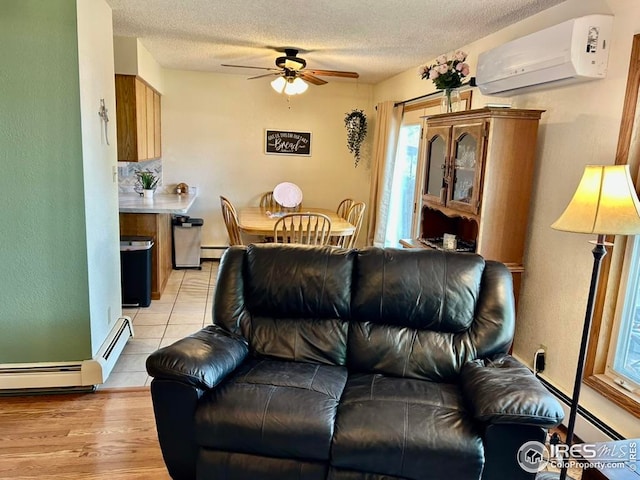 1722 Pheasant Rdg, Sterling, CO 80751 - living room featuring a wall unit AC, ceiling fan, a textured ceiling, and a baseboard heating unit
