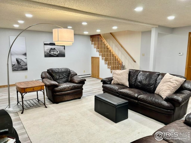 1722 Pheasant Rdg, Sterling, CO 80751 - living room featuring recessed lighting, stairs, light wood-type flooring, a textured ceiling, and a baseboard heating unit
