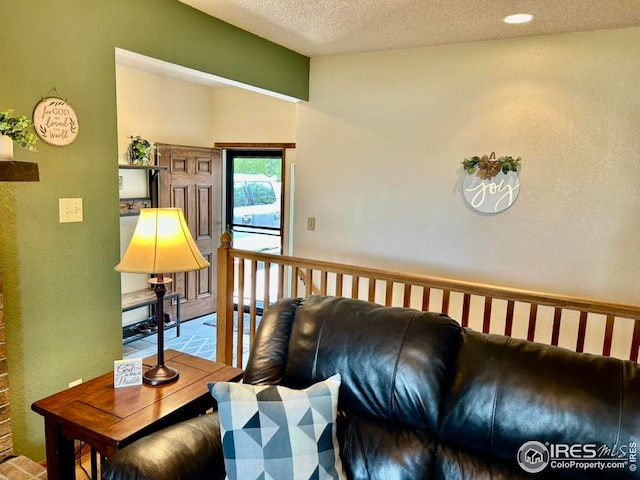 1722 Pheasant Rdg, Sterling, CO 80751 - living room featuring vaulted ceiling and a textured ceiling
