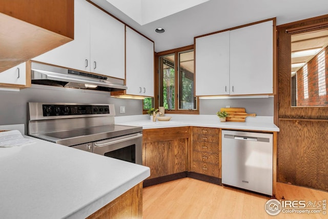 525 13th St, Boulder, CO 80302 - kitchen with under cabinet range hood, appliances with stainless steel finishes, light wood-type flooring, light countertops, and recessed lighting