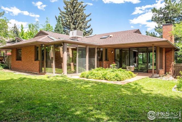 525 13th St, Boulder, CO 80302 - rear view of property with a sunroom, a chimney, and brick siding