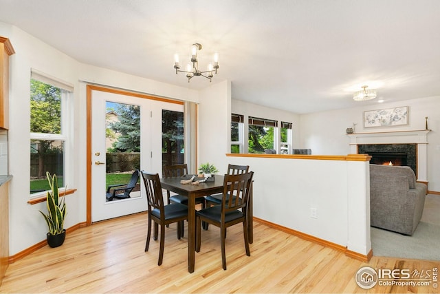 3514 Copper Spring Dr, Fort Collins, CO 80528 - dining space with a chandelier, wood finished floors, and a fireplace