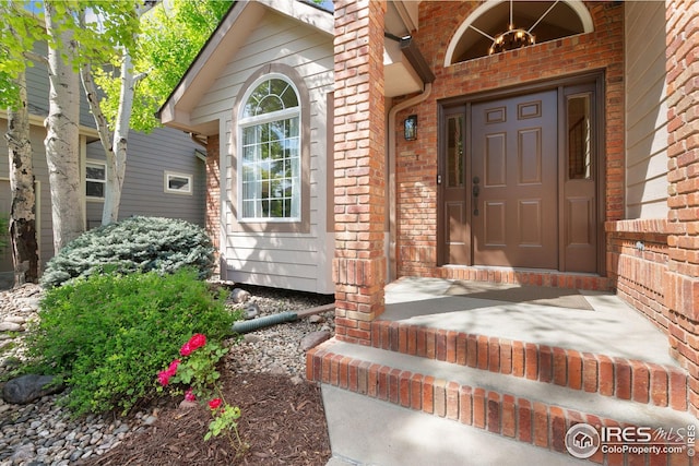 3514 Copper Spring Dr, Fort Collins, CO 80528 - view of exterior entry with brick siding and a porch