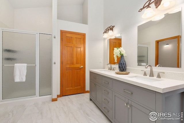 3514 Copper Spring Dr, Fort Collins, CO 80528 - full bathroom with double vanity, a shower stall, marble finish flooring, and high vaulted ceiling